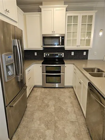 a kitchen with a refrigerator stove and cabinets