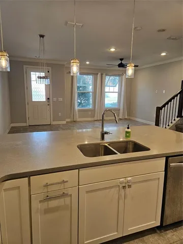 a kitchen with a sink and white cabinets