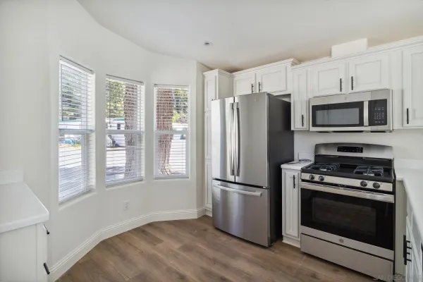 a kitchen with wooden cabinets and stainless steel appliances