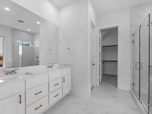 a spacious bathroom with a double vanity sink double and mirror