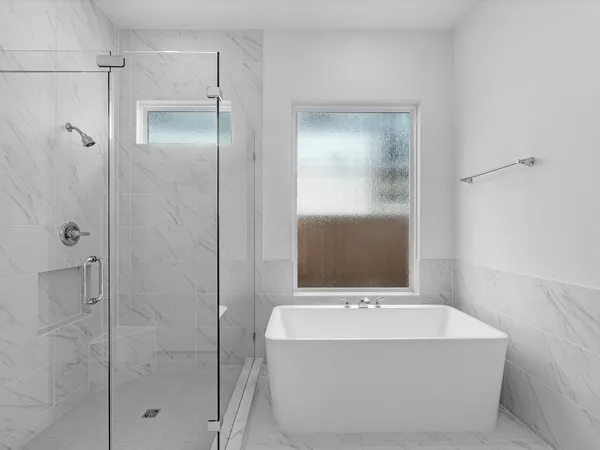 a bathroom with a bathtub and shower