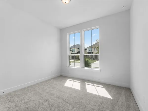 an empty room with a empty space and windows