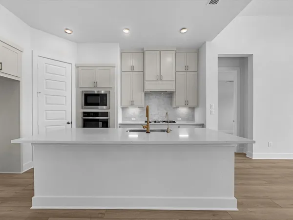 a kitchen with kitchen island cabinets and stainless steel appliances