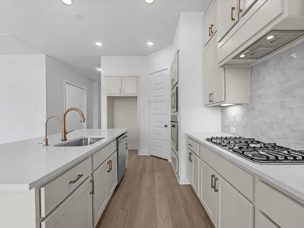 a kitchen with stainless steel appliances granite countertop a sink stove and cabinets