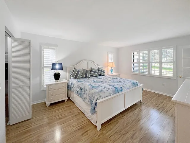 a bedroom with a large bed and a large window