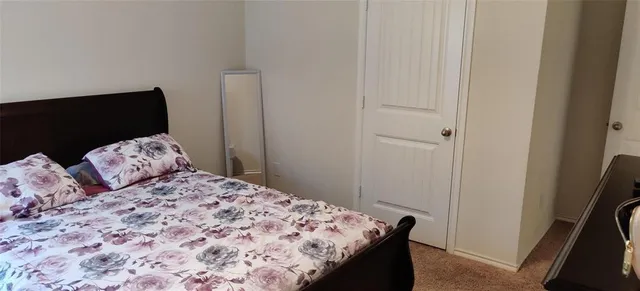 a bedroom with a bed and a tv