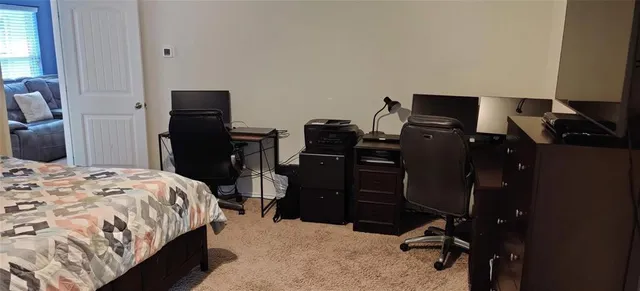 a bedroom with a bed and a television