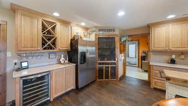 a kitchen with a refrigerator and a sink