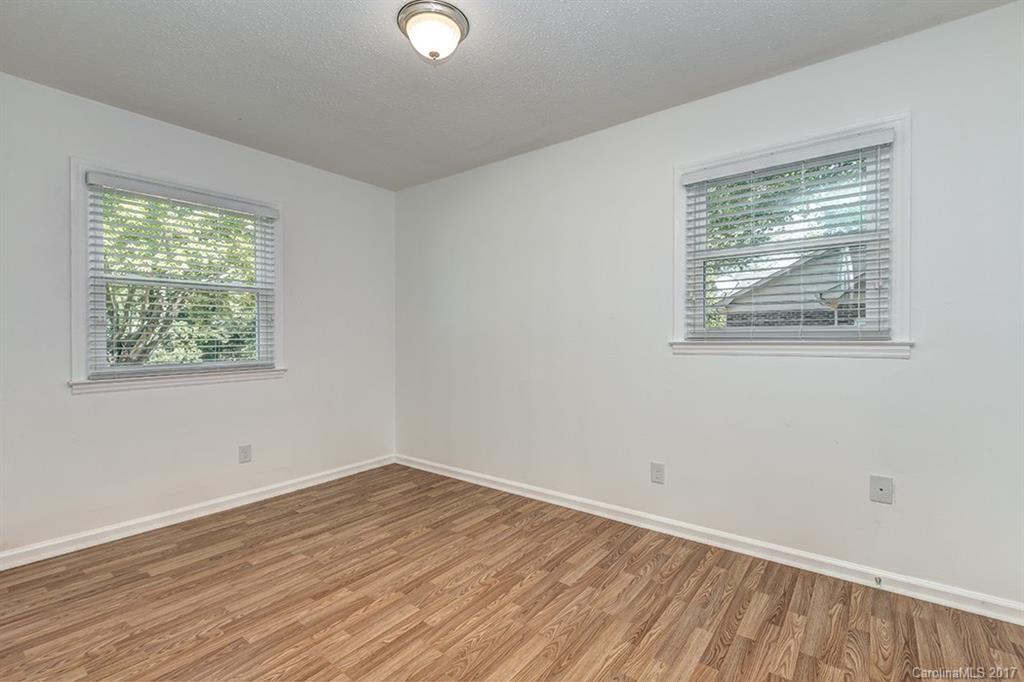 1705 Rushing Street, Unit 38 Monroe, NC 28112 - Photo 12 of 21 a view of an empty room with wooden floor and a window