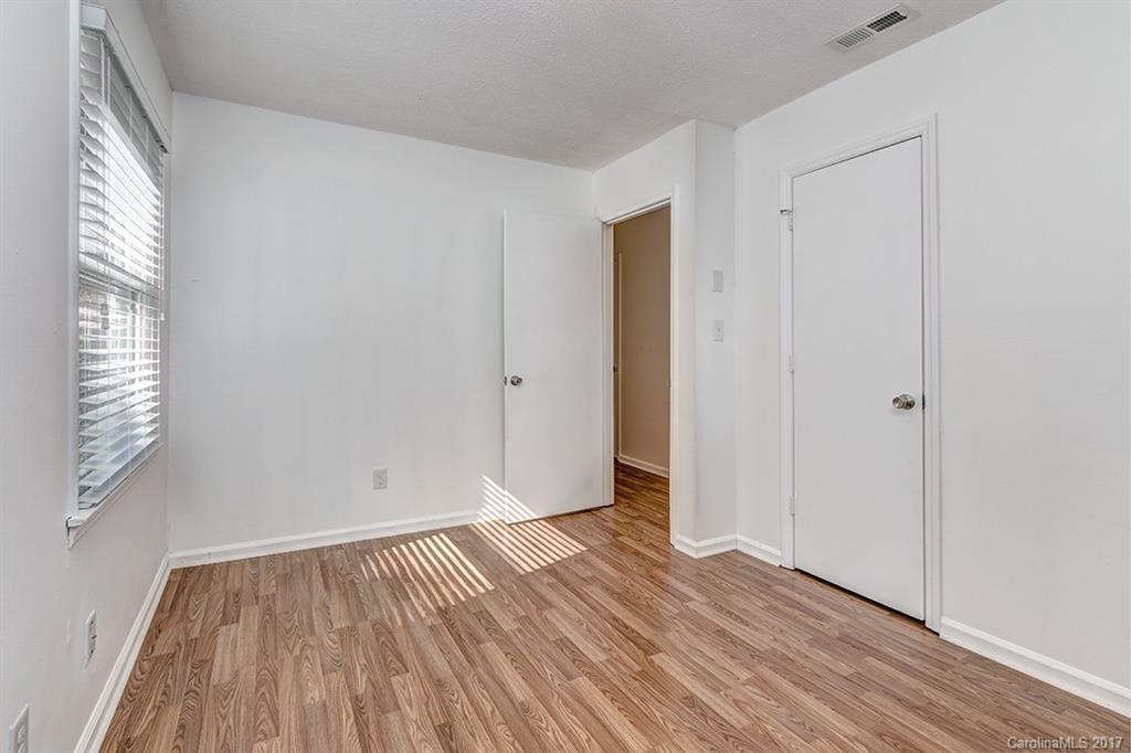 1705 Rushing Street, Unit 38 Monroe, NC 28112 - Photo 13 of 21 a view of an empty room with wooden floor and a window
