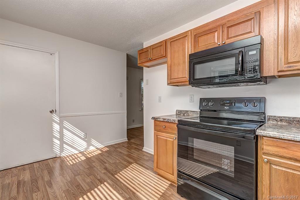 1705 Rushing Street, Unit 38 Monroe, NC 28112 - Photo 3 of 21 a kitchen with stainless steel appliances a stove microwave and sink