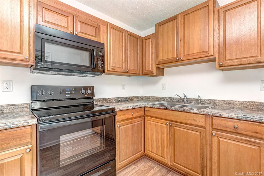 1705 Rushing Street, Unit 38 Monroe, NC 28112 - Photo 4 of 21 a kitchen with granite countertop cabinets stainless steel appliances and a sink
