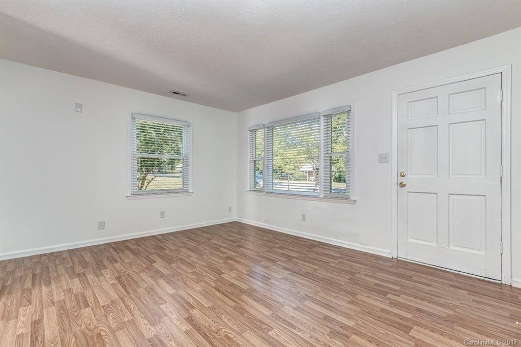 1705 Rushing Street, Unit 38 Monroe, NC 28112 - Photo 7 of 21 an empty room with wooden floor and windows