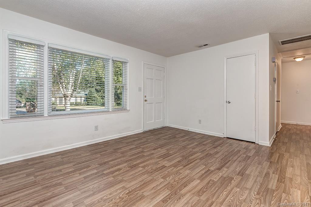 1705 Rushing Street, Unit 38 Monroe, NC 28112 - Photo 8 of 21 a view of an empty room with wooden floor and a window