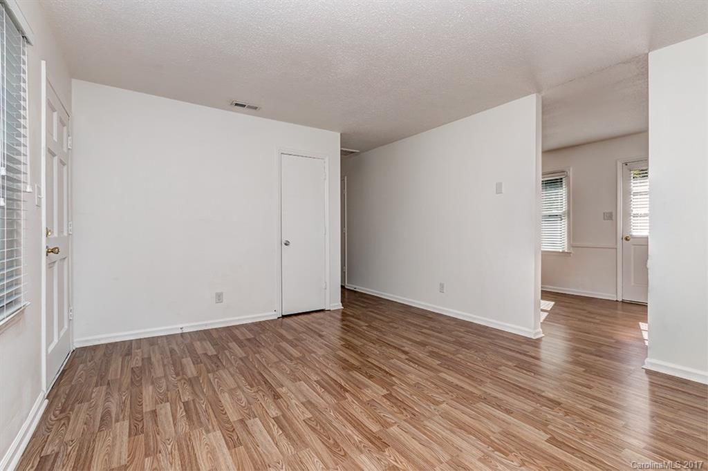 1705 Rushing Street, Unit 38 Monroe, NC 28112 - Photo 9 of 21 a view of an empty room with wooden floor and a window