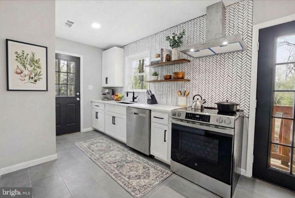 a kitchen with a stove top oven sink and cabinets