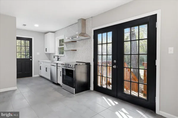 a kitchen with stainless steel appliances granite countertop a stove and a refrigerator