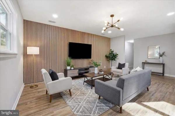 a living room with furniture or chandelier and a flat screen tv
