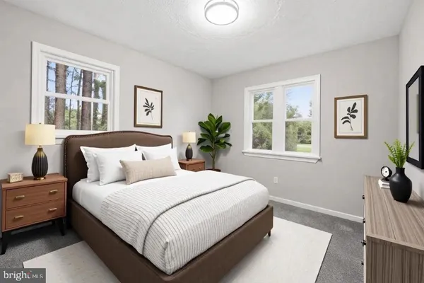 a bedroom with a bed potted plant and windows