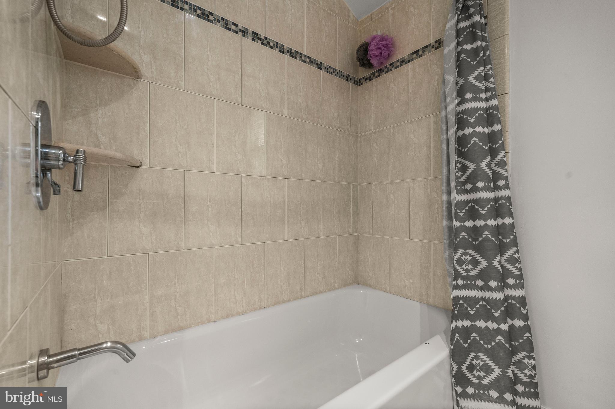 4244 Hildreth Street Southeast Washington, DC 20019 - Photo 19 of 31 a bathroom with a bathtub and shower