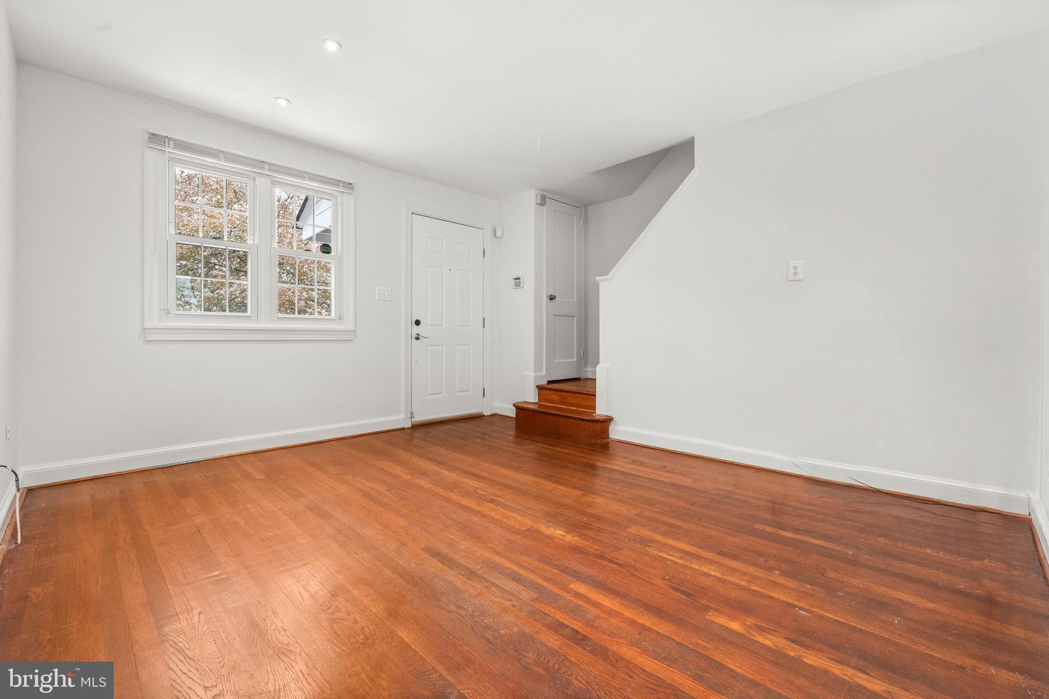 4244 Hildreth Street Southeast Washington, DC 20019 - Photo 3 of 31 an empty room with wooden floor and window