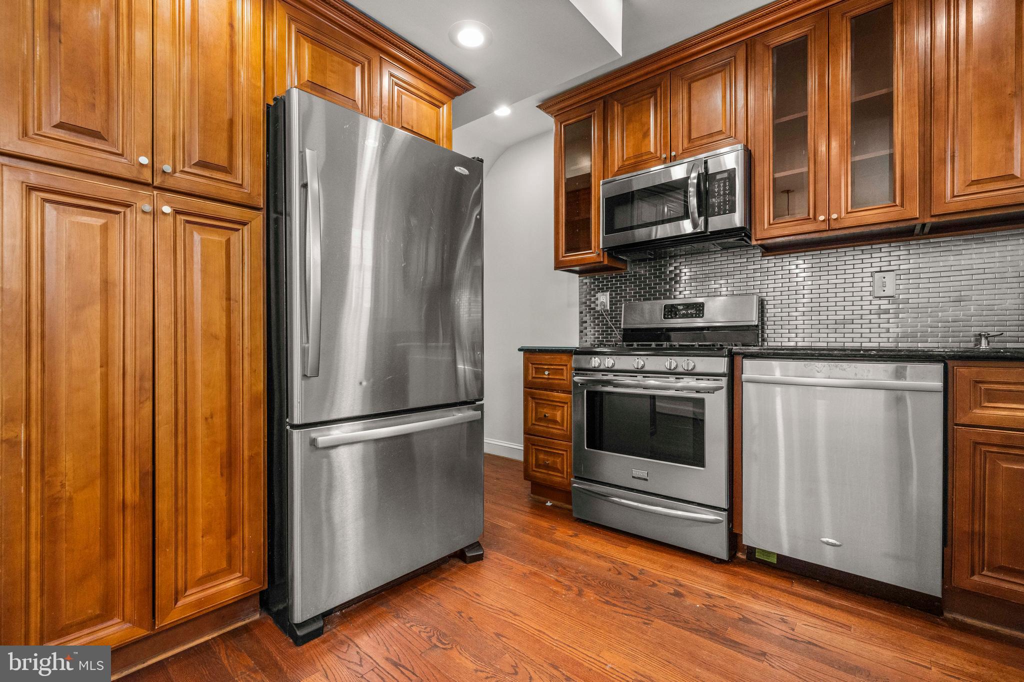 4244 Hildreth Street Southeast Washington, DC 20019 - Photo 6 of 31 a kitchen with stainless steel appliances granite countertop a refrigerator stove and microwave