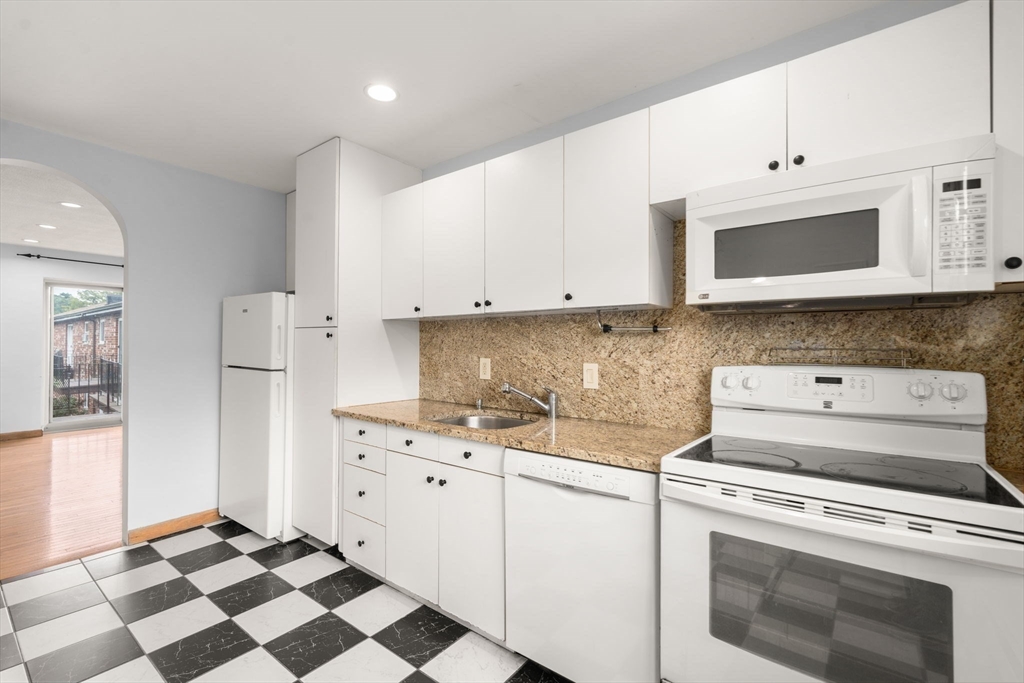 21 Westgate Road, Unit 6 Chestnut Hill, MA 02467 - Photo 2 of 28 a kitchen with granite countertop cabinets stainless steel appliances and a sink