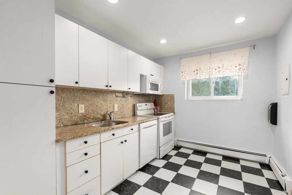 21 Westgate Road, Unit 6 Chestnut Hill, MA 02467 - Photo 3 of 28 a kitchen with granite countertop white cabinets and appliances