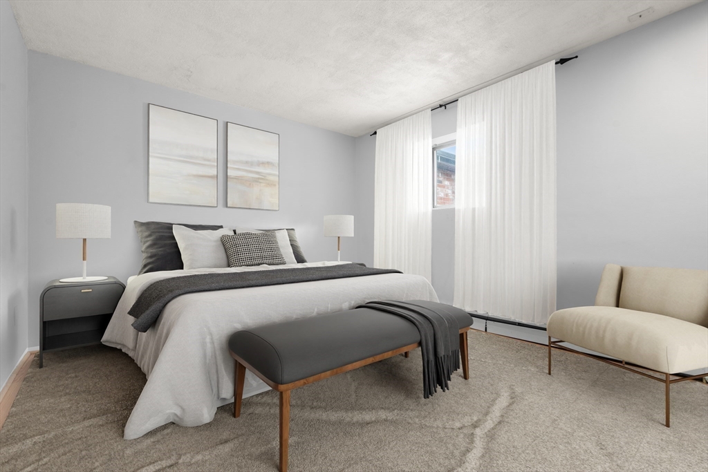 21 Westgate Road, Unit 6 Chestnut Hill, MA 02467 - Photo 6 of 28 a bedroom with a bed and a couch
