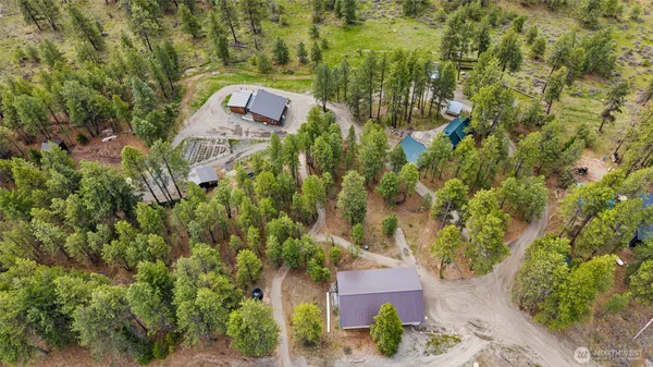 an aerial view of a house with a yard