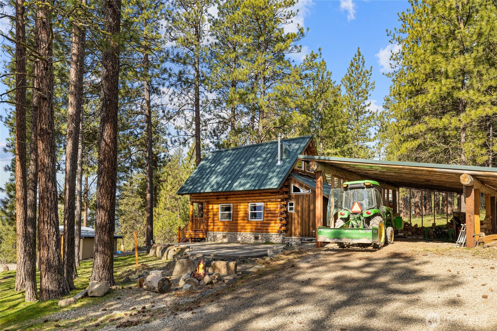 340 Powerline Road Cle Elum, WA 98922 - Photo 21 of 40 a view of a house with large windows and a tree