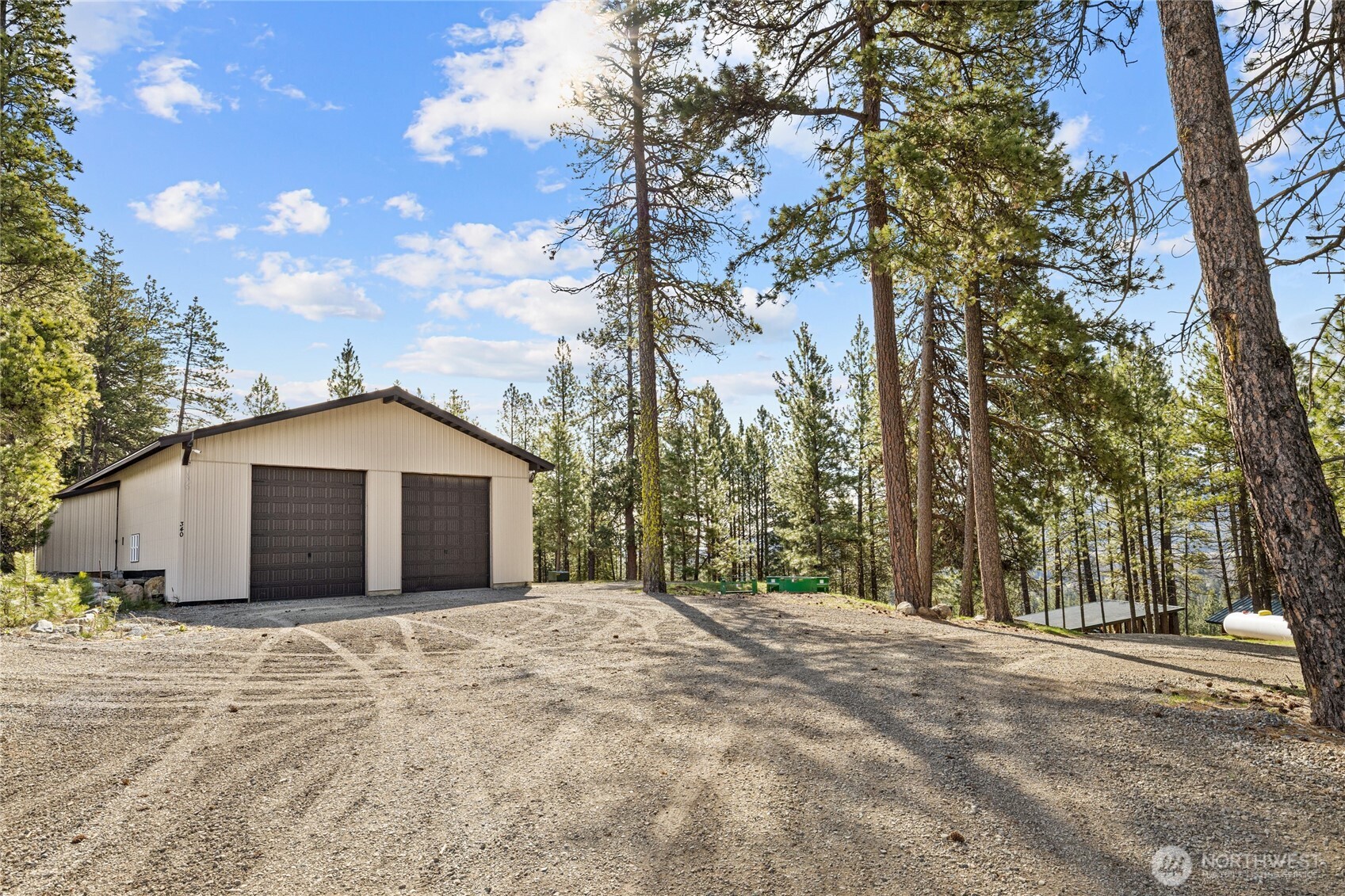 340 Powerline Road Cle Elum, WA 98922 - Photo 33 of 40 a view of a house with a large tree in front of it