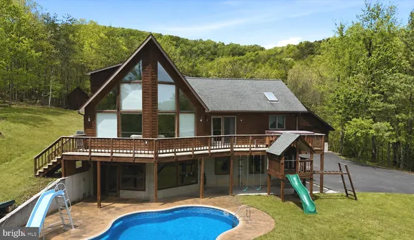 a aerial view of a house with a yard balcony and sitting area