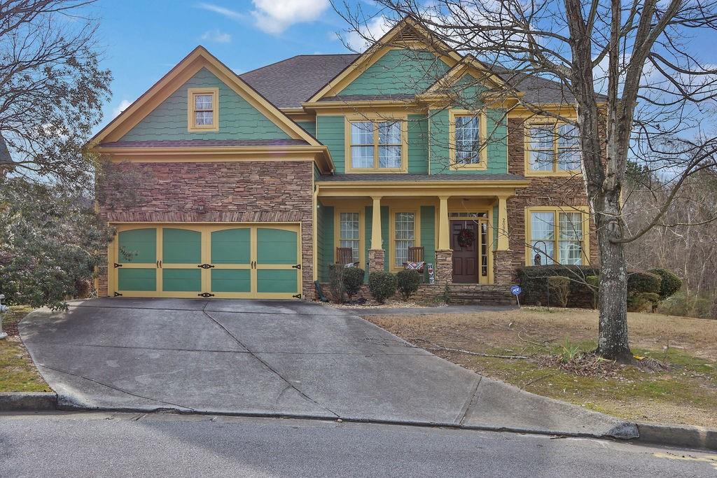 a front view of a house with garden and plants