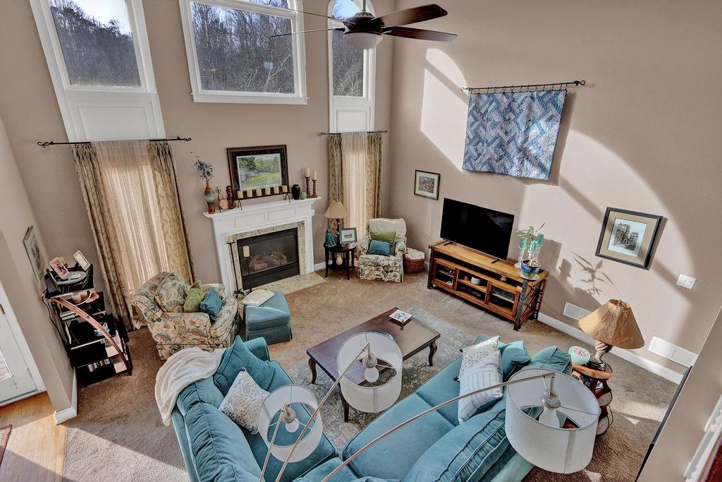 2095 Pinehurst View Drive Grayson, GA 30017 - Photo 13 of 45 a living room with furniture a fireplace and a flat screen tv