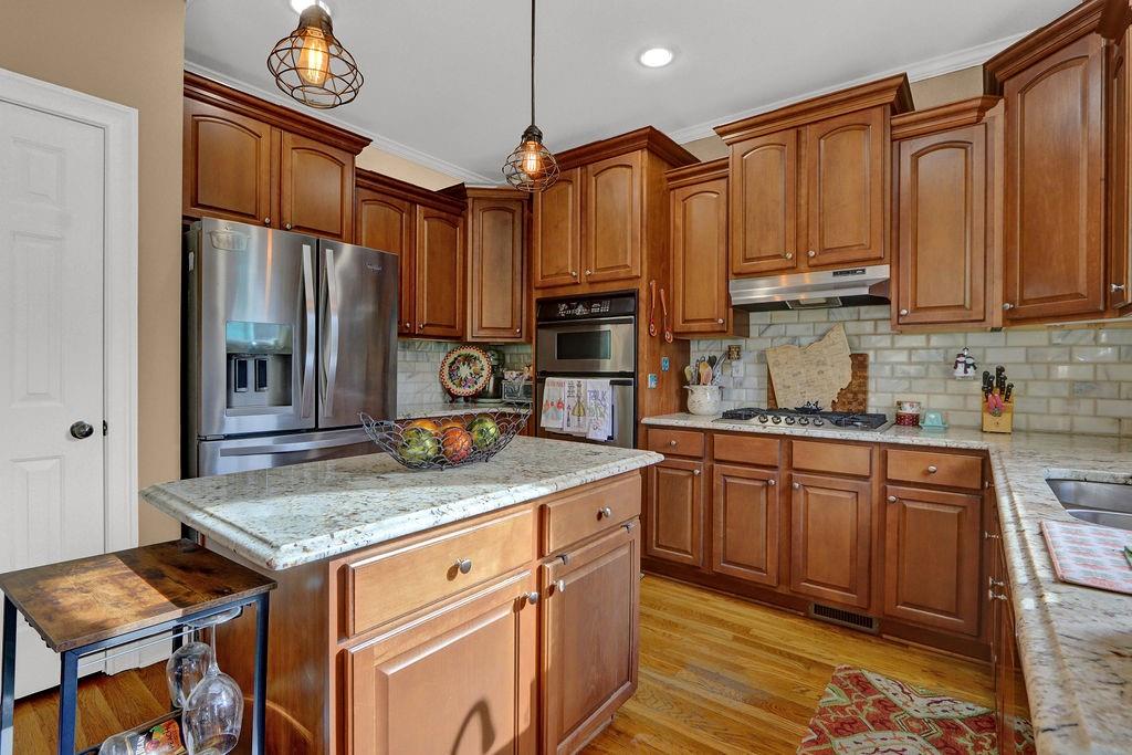 2095 Pinehurst View Drive Grayson, GA 30017 - Photo 18 of 45 a kitchen with stainless steel appliances granite countertop a stove a sink and a refrigerator