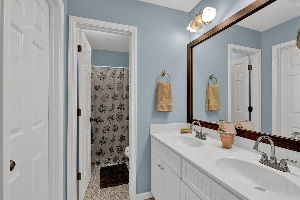 2095 Pinehurst View Drive Grayson, GA 30017 - Photo 23 of 45 a bathroom with a double vanity sink and a mirror
