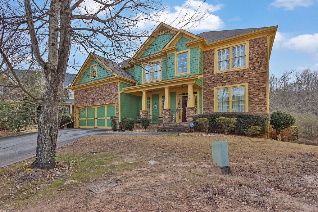 2095 Pinehurst View Drive Grayson, GA 30017 - Photo 3 of 45 a front view of a house with a yard and trees