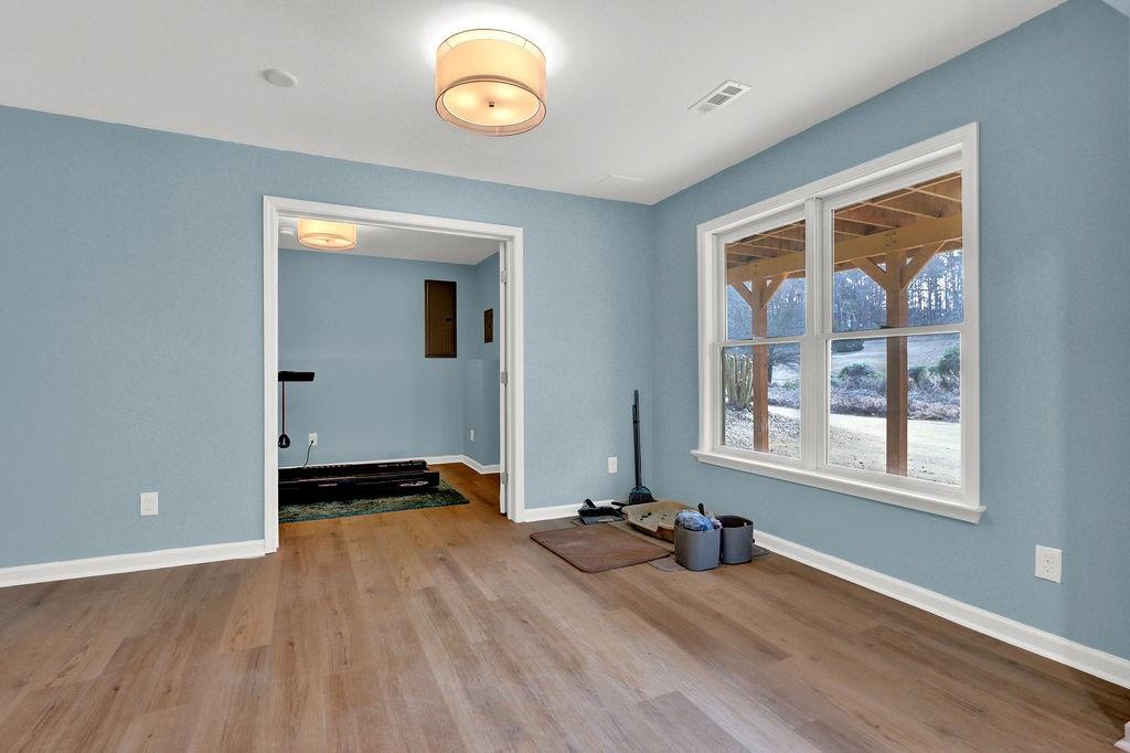 2095 Pinehurst View Drive Grayson, GA 30017 - Photo 31 of 45 an empty room with wooden floor and windows