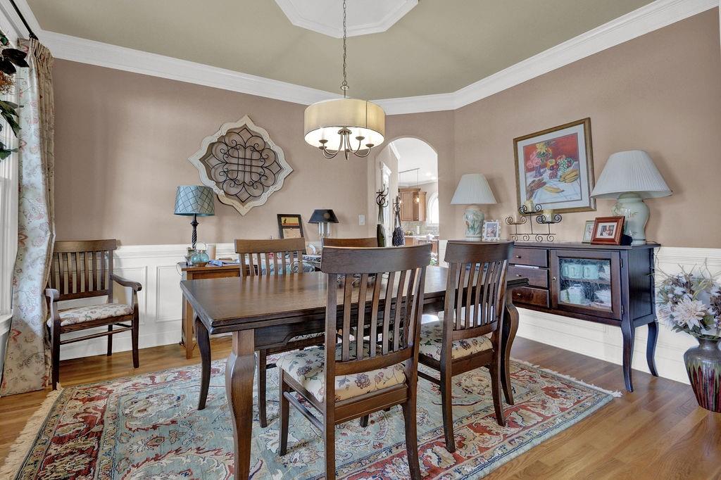 2095 Pinehurst View Drive Grayson, GA 30017 - Photo 6 of 45 a view of a dining room with furniture wooden floor and a chandelier