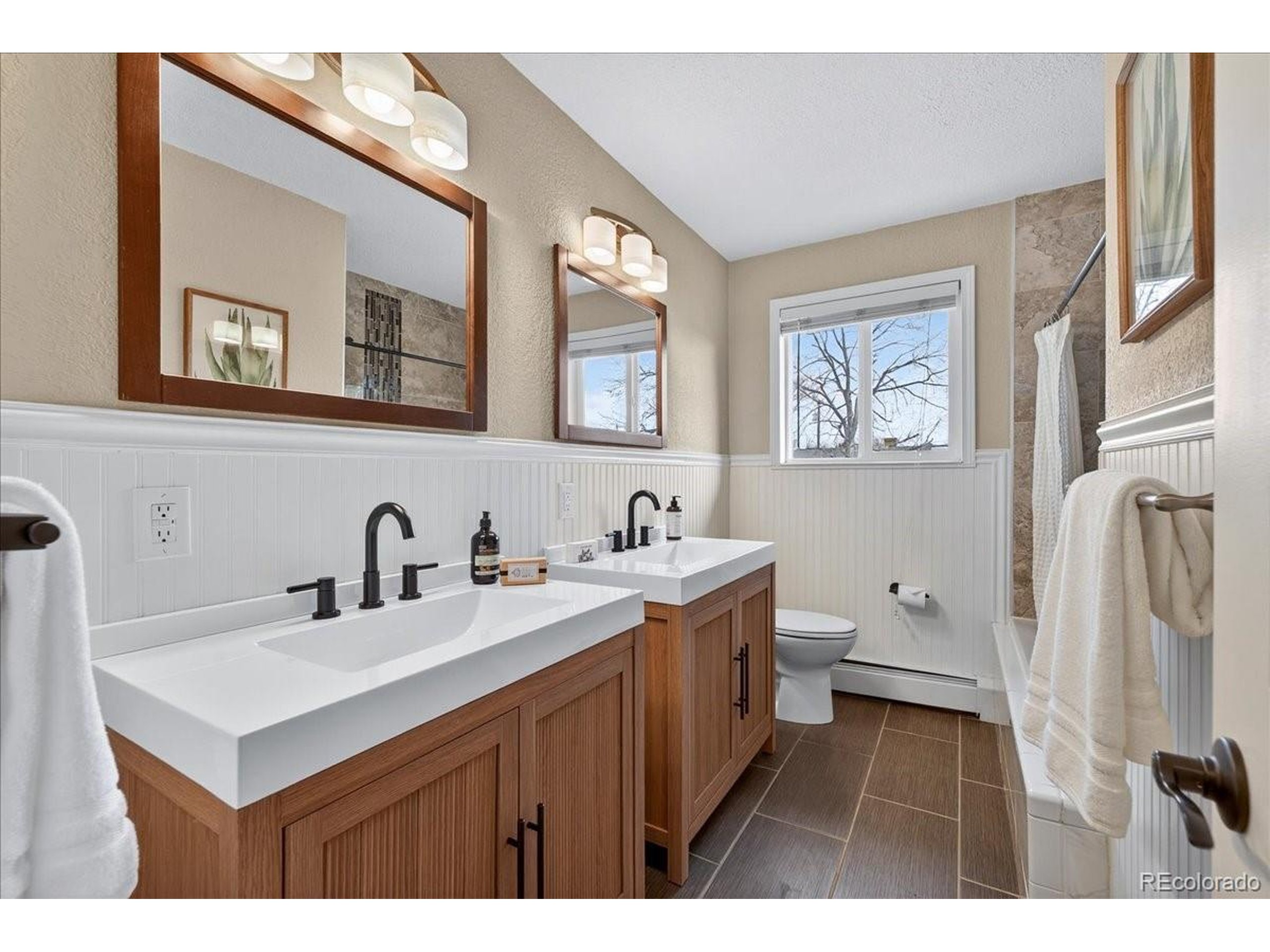 3135 Wright Court Wheat Ridge, CO 80215 - Photo 19 of 50 a bathroom with a sink a toilet and a mirror