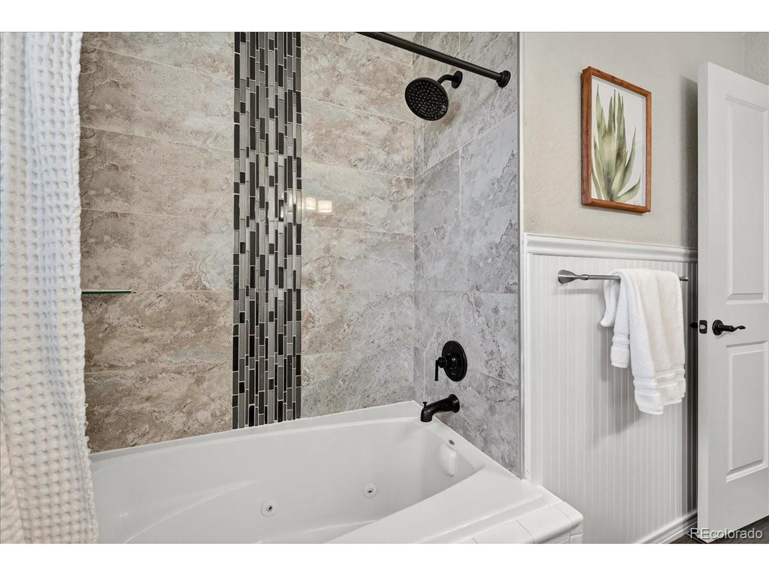 3135 Wright Court Wheat Ridge, CO 80215 - Photo 20 of 50 a bathroom with a bathtub and shower