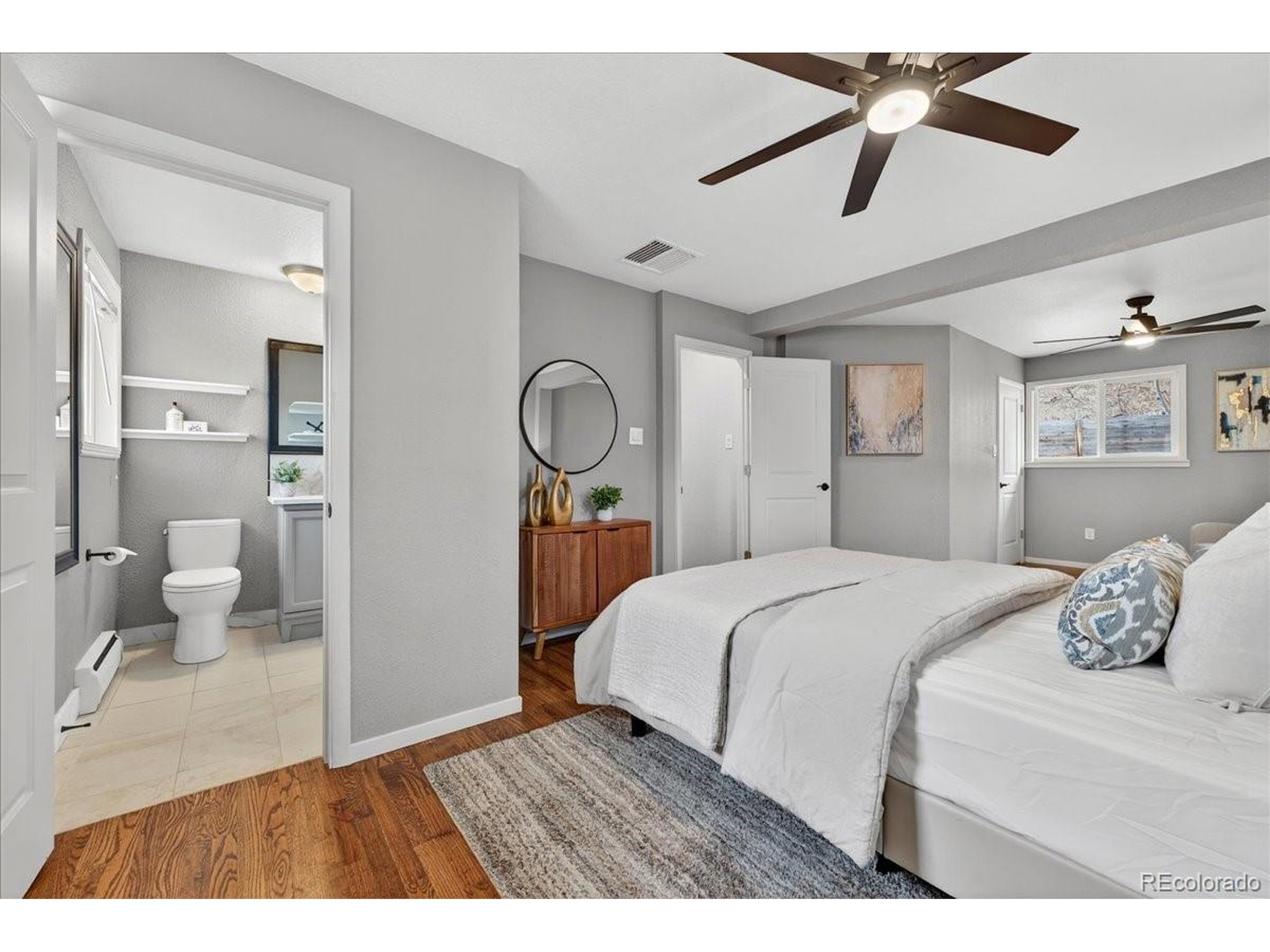 3135 Wright Court Wheat Ridge, CO 80215 - Photo 25 of 50 a bedroom with a bed and a chandelier