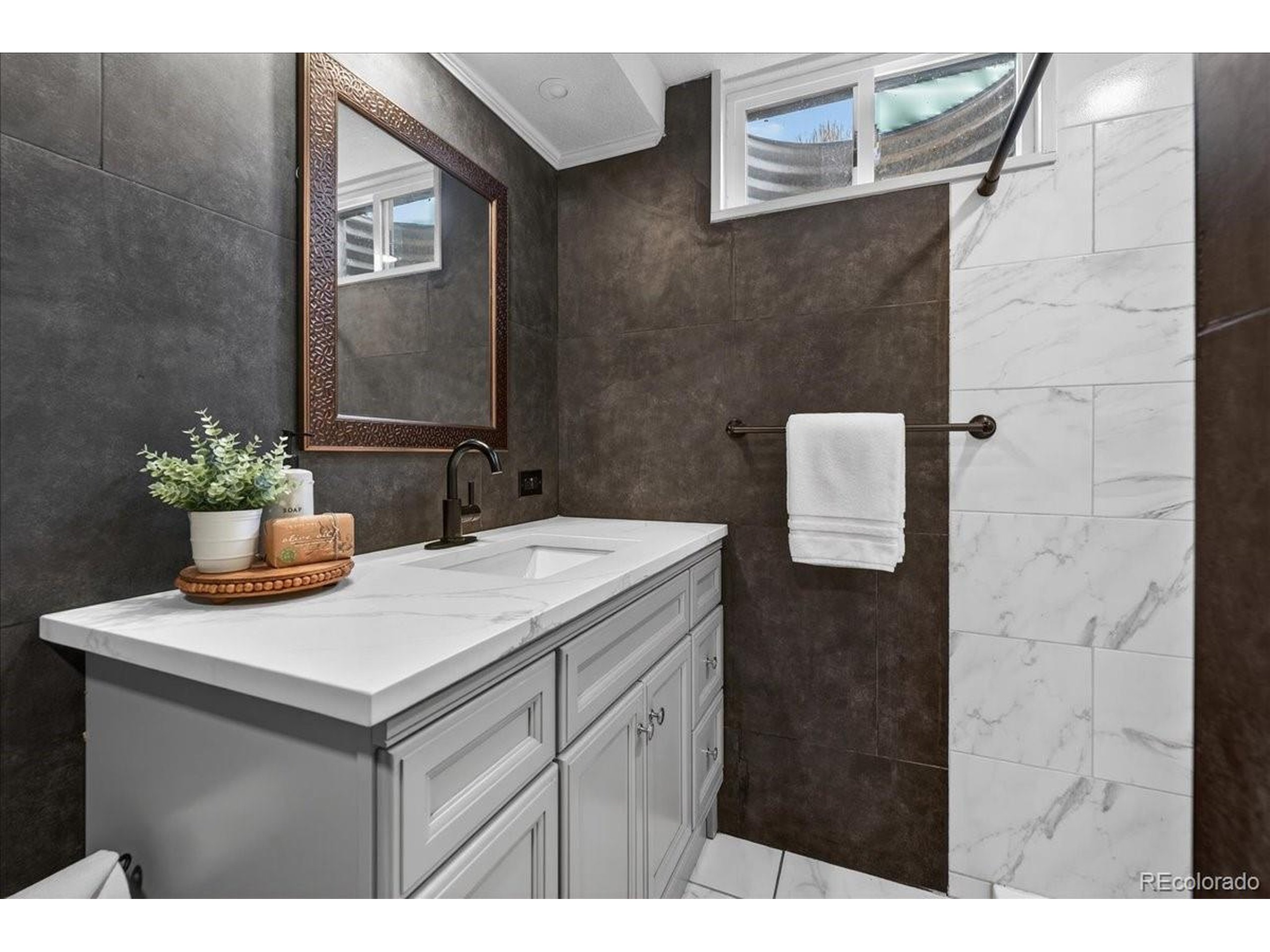3135 Wright Court Wheat Ridge, CO 80215 - Photo 33 of 50 a bathroom with a sink and a mirror
