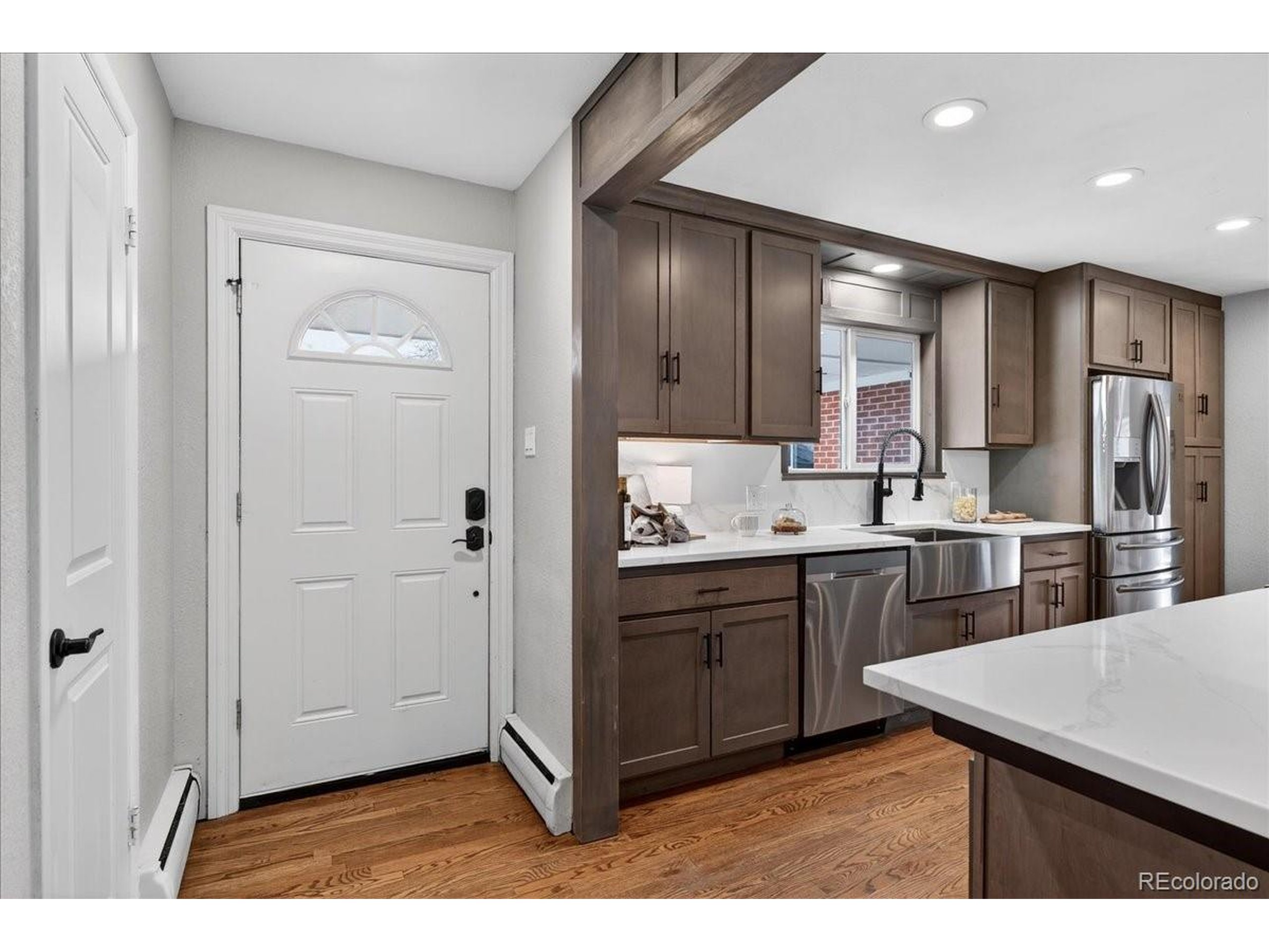 3135 Wright Court Wheat Ridge, CO 80215 - Photo 4 of 50 a kitchen with cabinets and stainless steel appliances