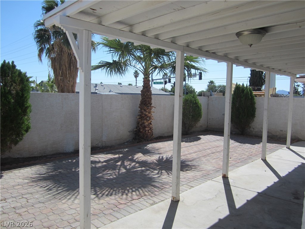 2882 Sandyfalls Way Las Vegas, NV 89142 - Photo 17 of 18 A spacious covered patio features durable paver flooring, perfect for outdoor enjoyment.