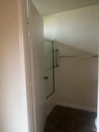 a bathroom with a granite countertop toilet and a sink