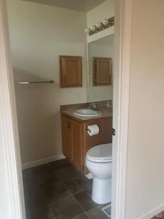 a view of a room with wooden floor and a window