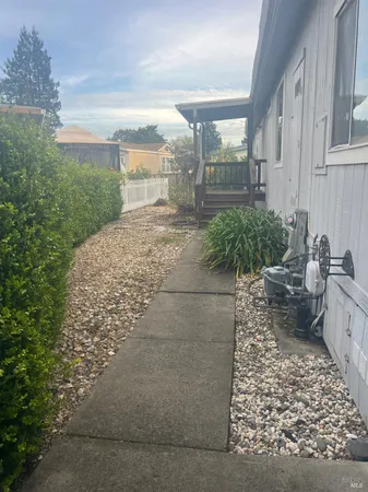 a view of a pathway both side of house