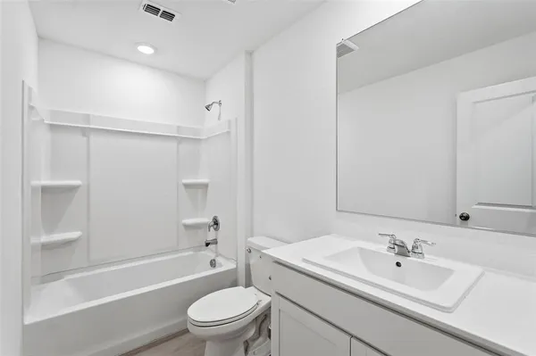 a bathroom with a sink a toilet and a bathtub